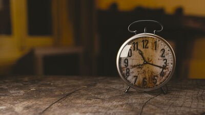 Vintage clock sitting on a wood table