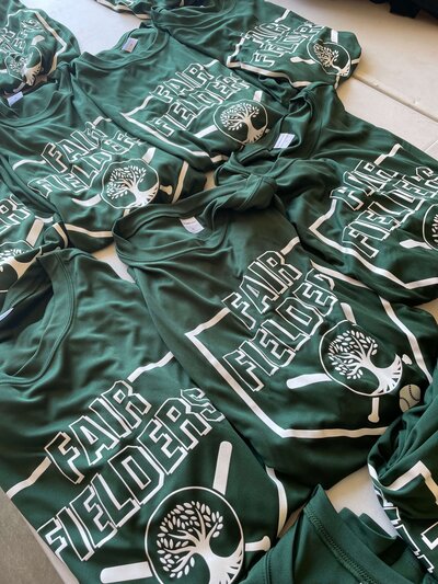 Fair Fielders screen printed athletic green shirts for sports are laid out and ready to be shipped!