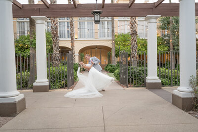 bride and groom dip in front of hotel in Chandler