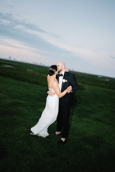 Bride and groom share a kiss on the golf course at Atlantic City Country Club in New Jersey