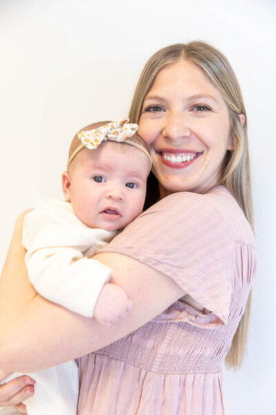Woman smiling as she holds her baby