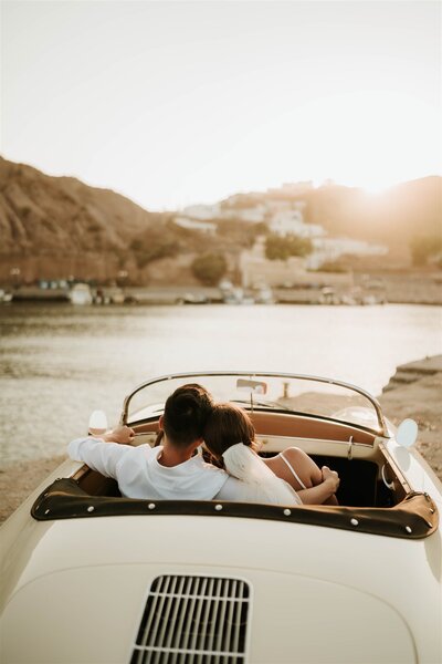 couple in car at sunset cuddling