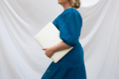 Graphic, web and branding designer Bess Brownlee walks with her laptop outside in Missoula, Montana.