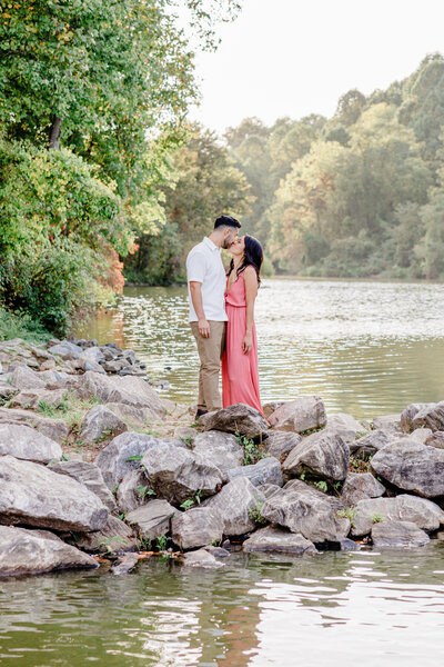 newlyweds looking at each other holding bouquet