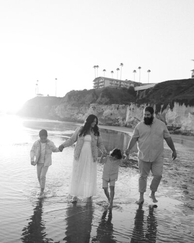 Family Photoshoot in Pismo Beach on the Central Coast with family candid walk holding hands
