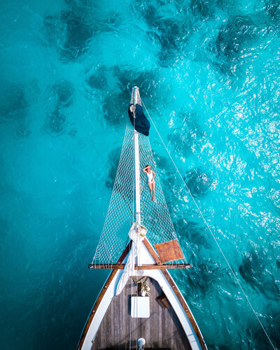 Aerial shot of front of boat on turquoise water