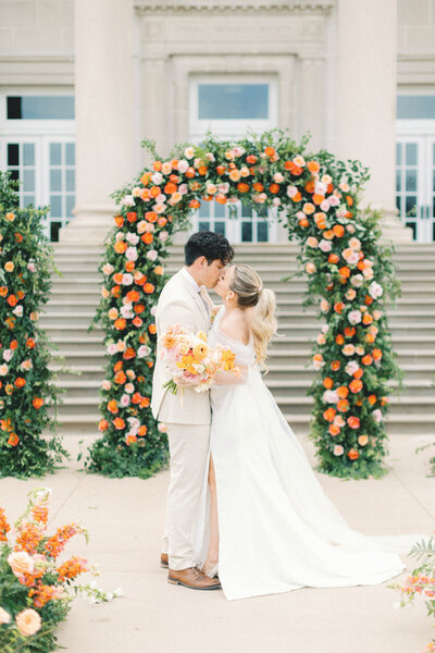 bride and groom snuggling in trees