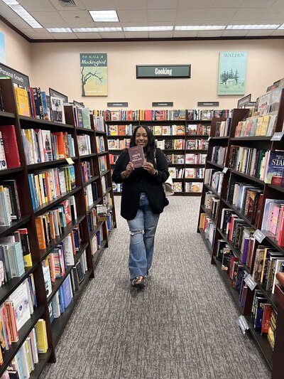 woman holding book in barnes and noble