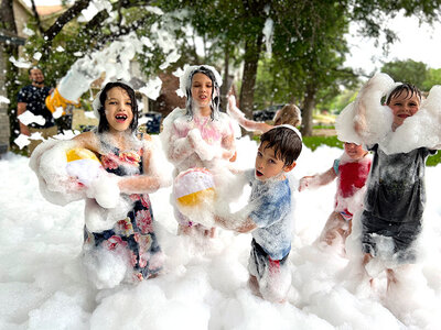 Group of children playing in foam