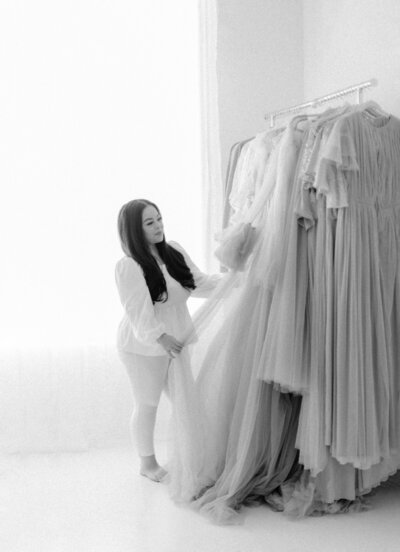 Las Vegas Maternity Photographer, Kristina standing my her maternity gowns for her clients maternity sessions. 