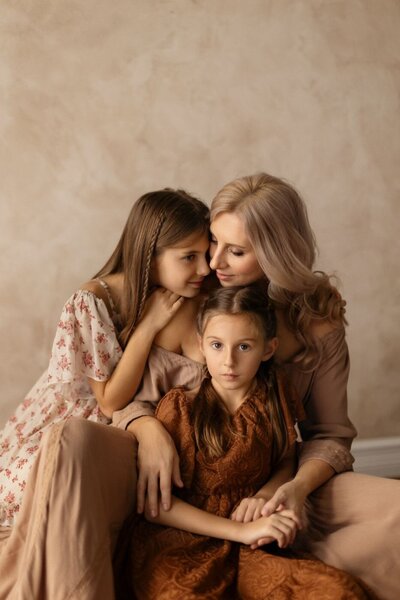 Miami photographer captures beautiful indoor portrait of mother with two daughters, showcasing family connection