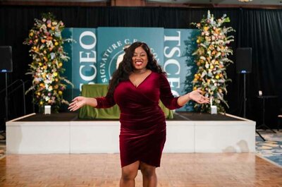 Black female wedding planner in grey dress smiling in Alexandria virginia