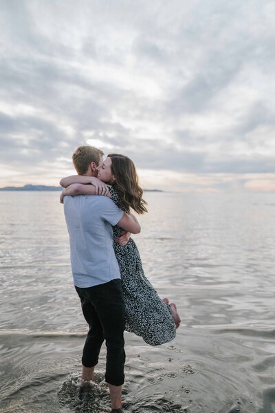 Sacramento Wedding Photographer captures woman jumping in man's arms during beach engagements
