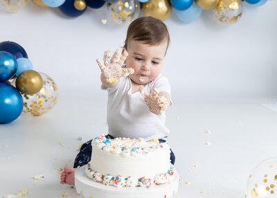 Light and airy lifestyle portrait of a baby at a 1st birthday cake smash photo session at Allison Reilly's Union County, NJ photo studio.