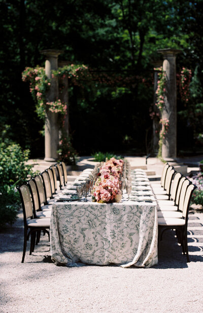A table set up with linens and florals at the Swan House in Atlanta, GA