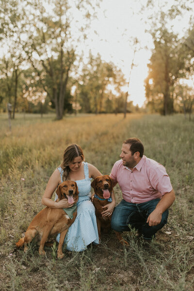 Photographer Heather with her husband and two puppies.