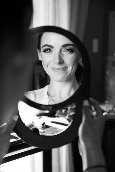 Black and white photo of bride during preparation
