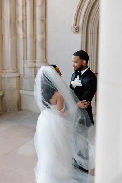 A bride lovingly glances at her new husband during their first look
