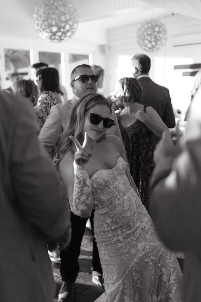 Bride poses on her wedding day on the dance floor for fun wedding photograph