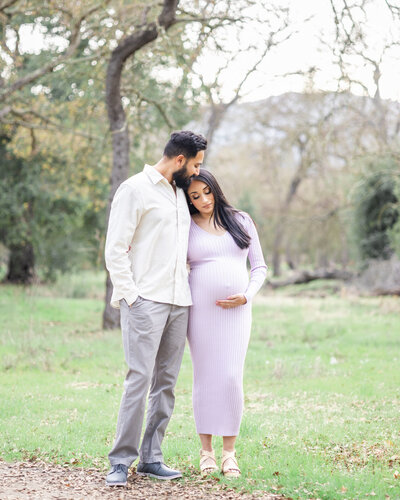Expectant parents share intimate moment with pregnant wife resting her head on husband's shoulder during San Jose maternity session