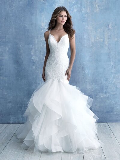 The subtly sequined bodice of this gown leads to a full, ruffled organza skirt.