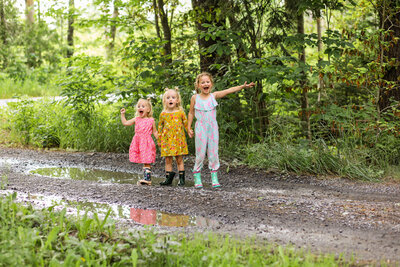 Three girls holding hands in rain boots | Family Photo Session