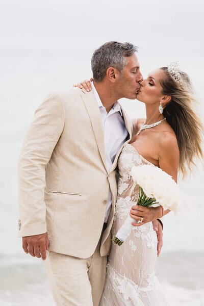 Bride and groom kissing at the beach in Miami photographed by Fort Myers wedding photographer