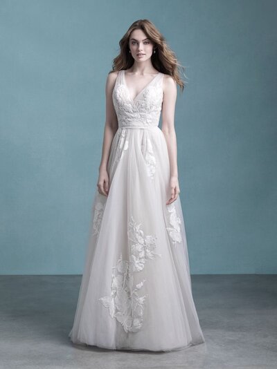 Scattered blossoms peek out from swaths of delicate tulle throughout this A-line gown.