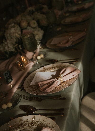 Moody wedding tablescape featuring candles, dark florals, and elegant place settings, perfect for an intimate NYC wedding