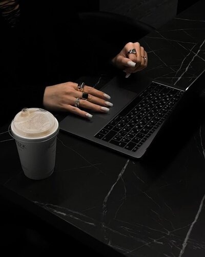 Mysterious woman on a laptop in the dark—symbolizing Clair’s discreet online investigations and behind-the-scenes dating safety checks.