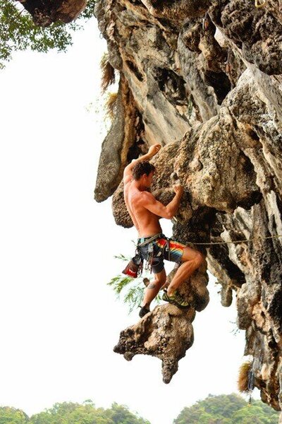 strong man rock climbing