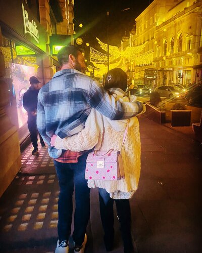 Photo of a couple with arms around each other