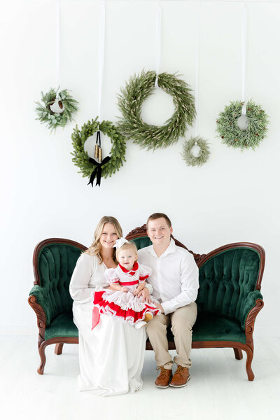 Family sitting on christmas couch during mini sessions