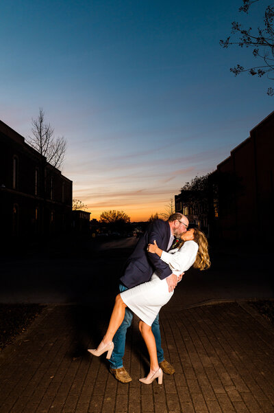Sunset photo of couple kissing on the Square in Murfreesboro TN during sunset. Wearing cute casual elopement attire.