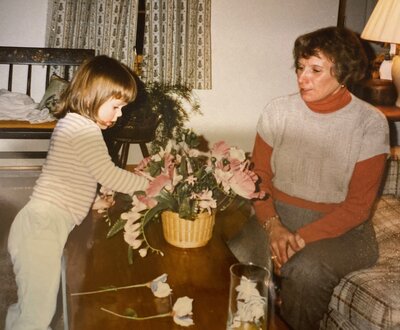 A florist and her grandma arrange flowers together.