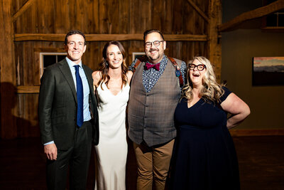 A wedding couple and Loren and Mary Beth of Adore Wedding Photography posing for a photo at Zingermans Cornman Farms