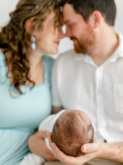 couple admiring their newborn baby
