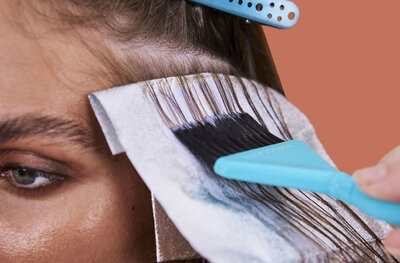 "Hairdresser applying vibrant hair color highlights in a top-rated Sydney hair studio