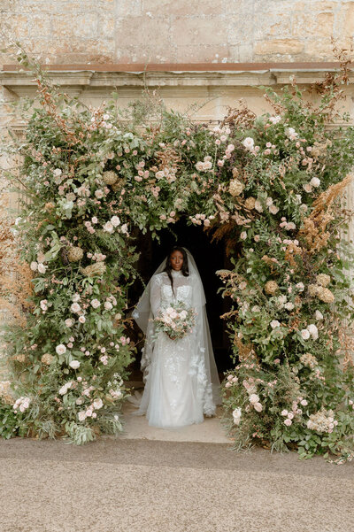 flower arch and bride