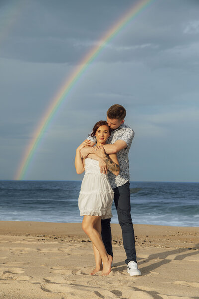 Spring Lake | Couple hugging on Rainbow Beach during engagement photo | New Jersey
