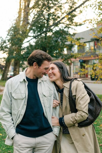 Recently engaged couple smiling at each other downtown Halifax.