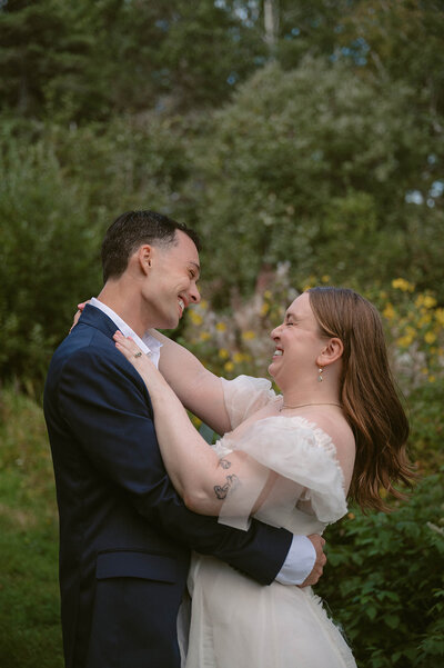 bride and groom look at each other like they are proud
