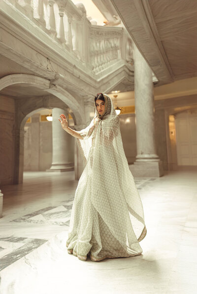 Women looking right, wearing white, brown hair,