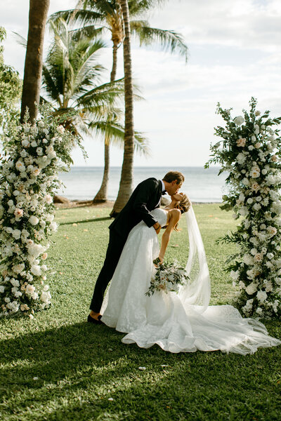 bride and groom holding hands down the aisle