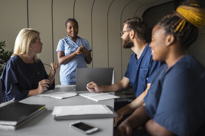 Dentists sitting at a large conference table during a meeting.