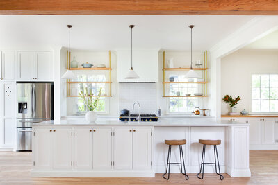 white kitchen with brass fixtures and open shelving