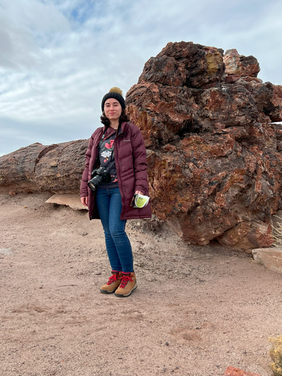 Woman with old faithful, a large petrified tree