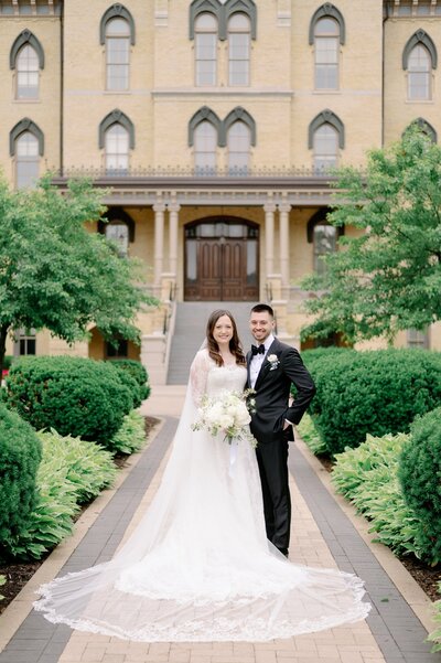 bride and groom posing together in wedding attire