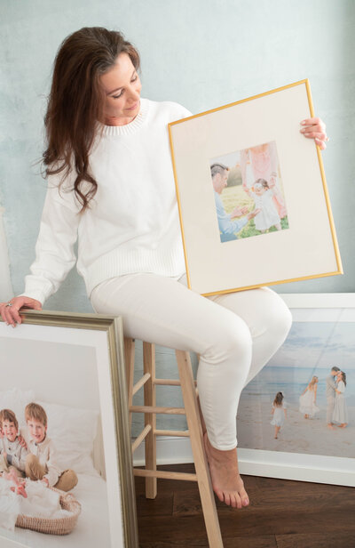 Jessica Jeremiah Photography holding framed prints