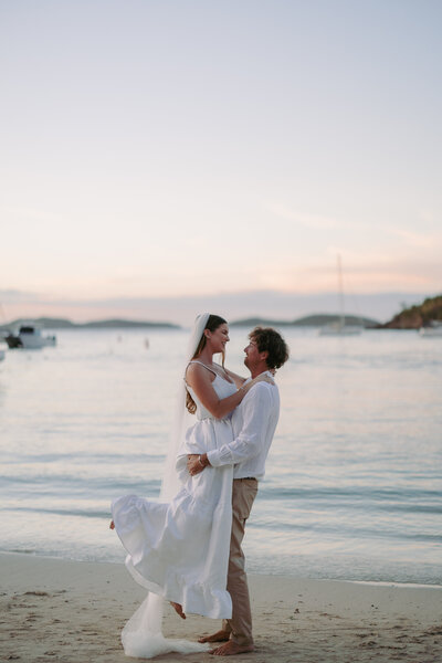 man and woman walking while holding hands and smiling at each other